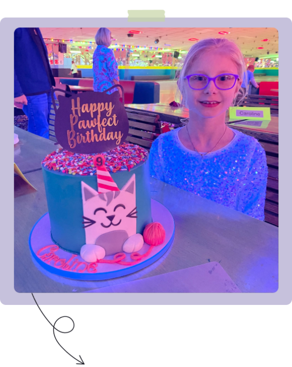 Caroline smiling with a cat cake