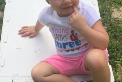 young girl sitting on the grass