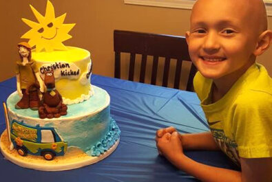 kid with a scooby doo cake