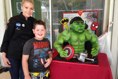 boy and woman with a hulk cake