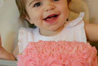 baby with a flowery cake