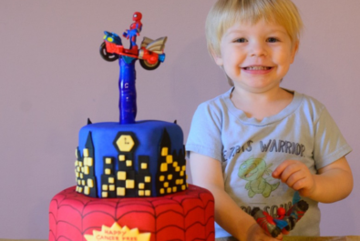 boy with a spider man cake