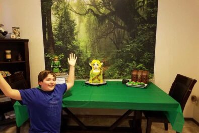 kid with a legend of zelda cake