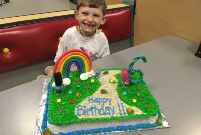 boy with a custom trolls cake