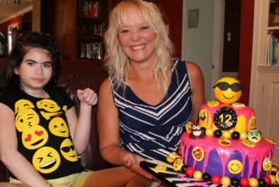 girl and mother with an emoji cake