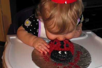 baby eating a ladybug cake