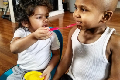 girl feeding a boy cake