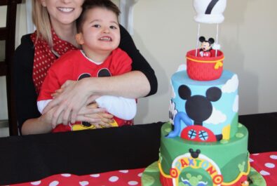 boy and woman with a mickey mouse cake