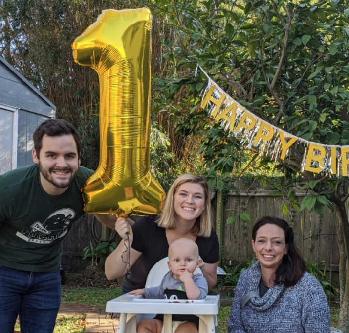 baby and family celebrating first birthday