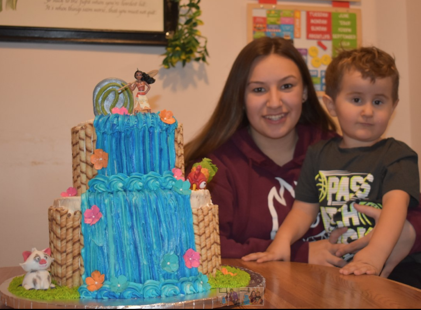 son and mother with a moana cake