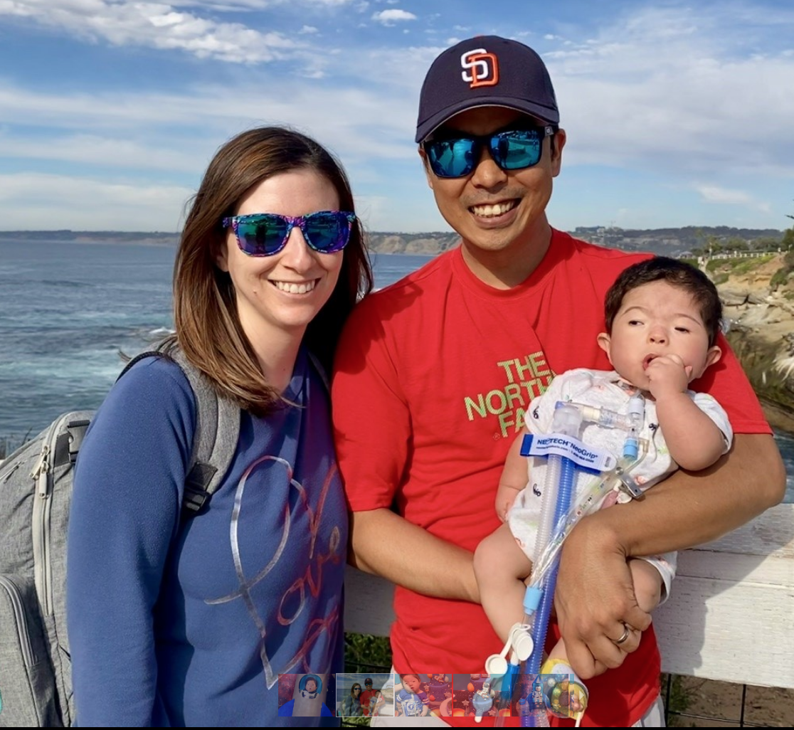 parents with a baby near the ocean