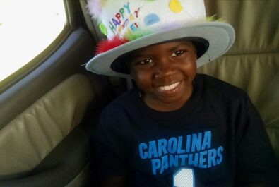 kid with a colorful party hat